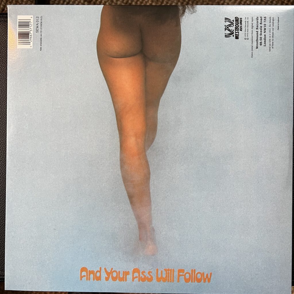 The back cover of "Free Your Mind and Your Ass Will Follow," depicting the lower half of the woman on the front cover, seen from the rear, her naked ass and legs being the only thing in the photograph. The second half of the title is printed below her feet.