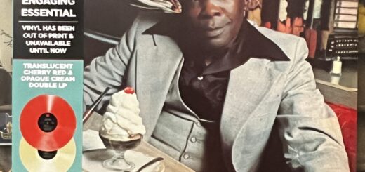 The Cream front cover – photograph of John Lee Hooker, a 60-something-year-old black man in a very dapper light colored three piece suit, a black silk or nylon shirt with an incredibly wide collar reaching to the shoulders of his suit jacket, and a tall, broad-brimmed light colored hat. He is seated at a diner table, a tabletop jukebox selector in the booth behind him. He has one arm resting on the table, the other on his knee, his left leg crossed on his right knee, he sits turned out from the booth. On the table is a heaping ice cream sundae covered in whipped cream with a cherry on top.