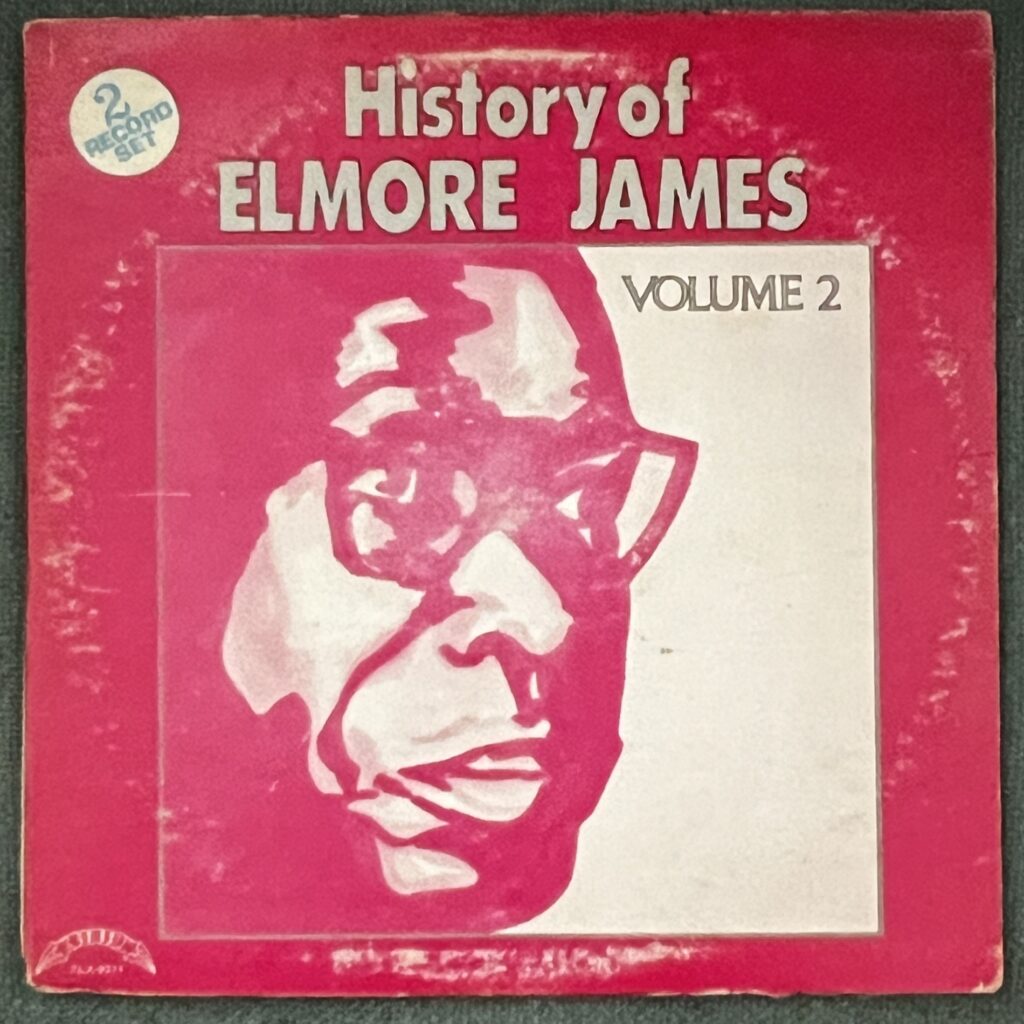 History of Elmore James Volume 2 front cover – a very simple red/pink background, with an artistic rendering of the face of Elmore James, a Black man wearing glasses, which is shown in two or three shades of red.