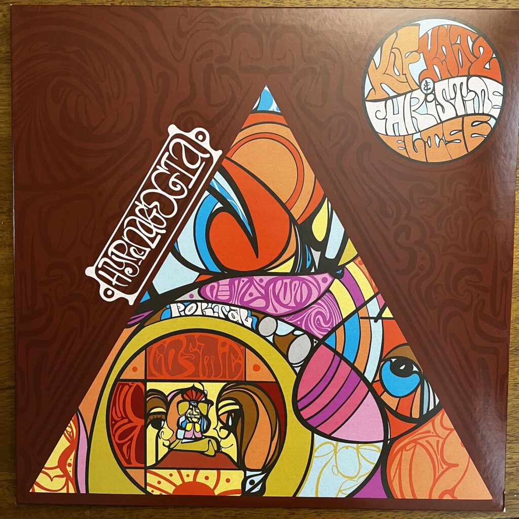 Hypnagogia front cover – album cover by Kuf Knotz and Christine Elise. Their names are in psychedelic style lettering in a circle in the upper right. Taking up most of the album cover is a triangle filled with other psychedelic colors and designs. Where the triangle isn't is filled with other designs in two dark shades.