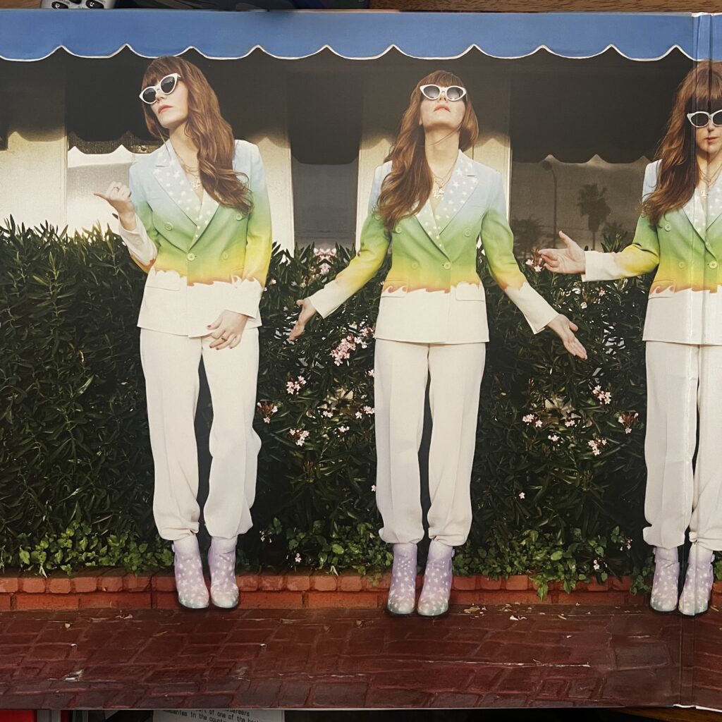 Voyager gatefold, showing multiple images of Jenny Lewis posing in front of a building