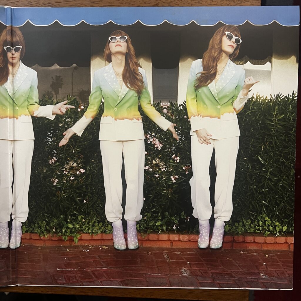 Voyager gatefold, showing multiple images of Jenny Lewis posing in front of a building