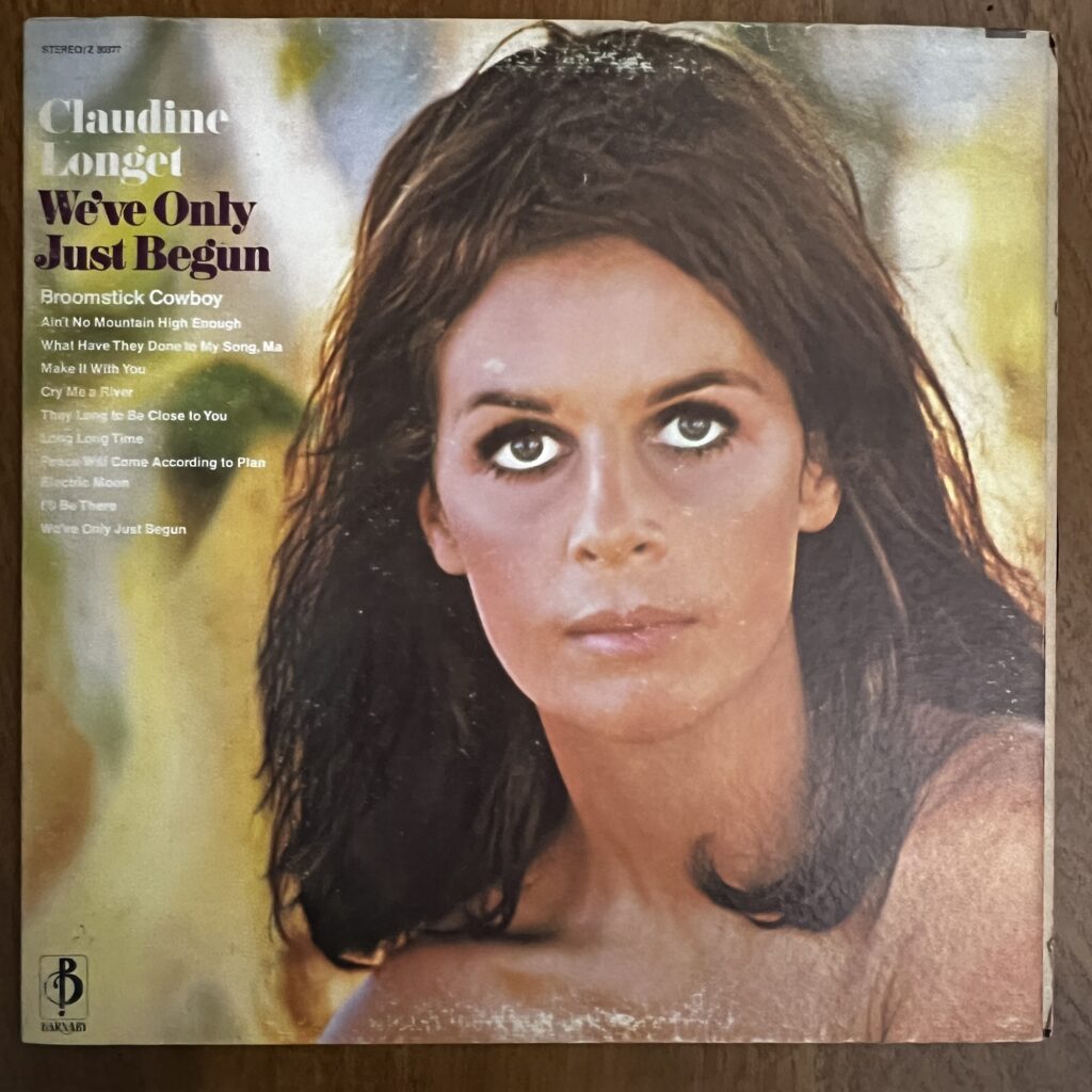 Claudine Longet We've Only Just Begun front cover – The title and song titles are in type on the left. The photograph shows the head and shoulders of Claudine Longet, with her shoulder-length straight brown hair appearing rather mussy and windswept, her large eyes looking straight ahead, little evident makeup other than mascara. Her expression is pleasant but blank, not smiling.