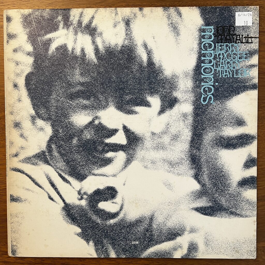 John Mayall Memories front cover – with a mezzotinted photograph of a young boy (Mayall) with a thick mop of hair, protruding ears and an open-mouthed but perhaps not smiling expression. He appears to be holding an infant, only half of which appears in the frame and has a face of typical infant distress.