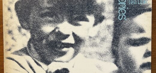John Mayall Memories front cover – with a mezzotinted photograph of a young boy (Mayall) with a thick mop of hair, protruding ears and an open-mouthed but perhaps not smiling expression. He appears to be holding an infant, only half of which appears in the frame and has a face of typical infant distress.