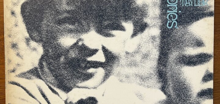 John Mayall Memories front cover – with a mezzotinted photograph of a young boy (Mayall) with a thick mop of hair, protruding ears and an open-mouthed but perhaps not smiling expression. He appears to be holding an infant, only half of which appears in the frame and has a face of typical infant distress.