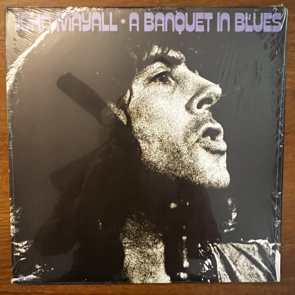 A Banquet In Blues front cover – with a dark, mezzotinted photograph of John Mayall's face in profile.