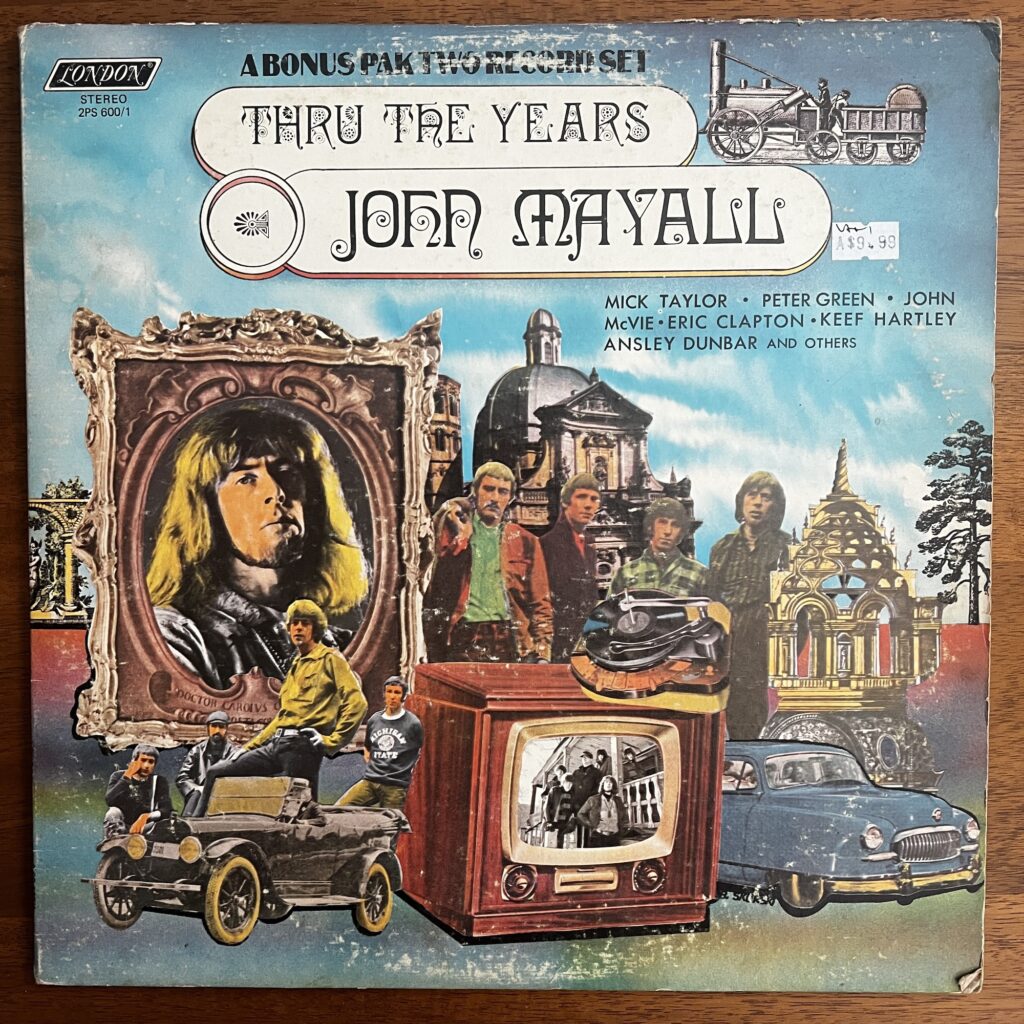 The cover of the two-disc set "Thru The Years" by John Mayall. The cover illustration is meant to evoke old times or nostalgia. There is the suggestion of a landscape, with darker foreground, a clear horizon line with a tree or two, and blue sky with light clouds throughout. Arranged in the foreground is a collage of disparate images, including a very antique car, a somewhat more modern car, a television set, and a record player. A giant framed photograph of John Mayall appears to the left; images of old landmark buildings are scattered across the scene. Cut out pictures of the musicians who played with Mayall are also arranged through the collage.