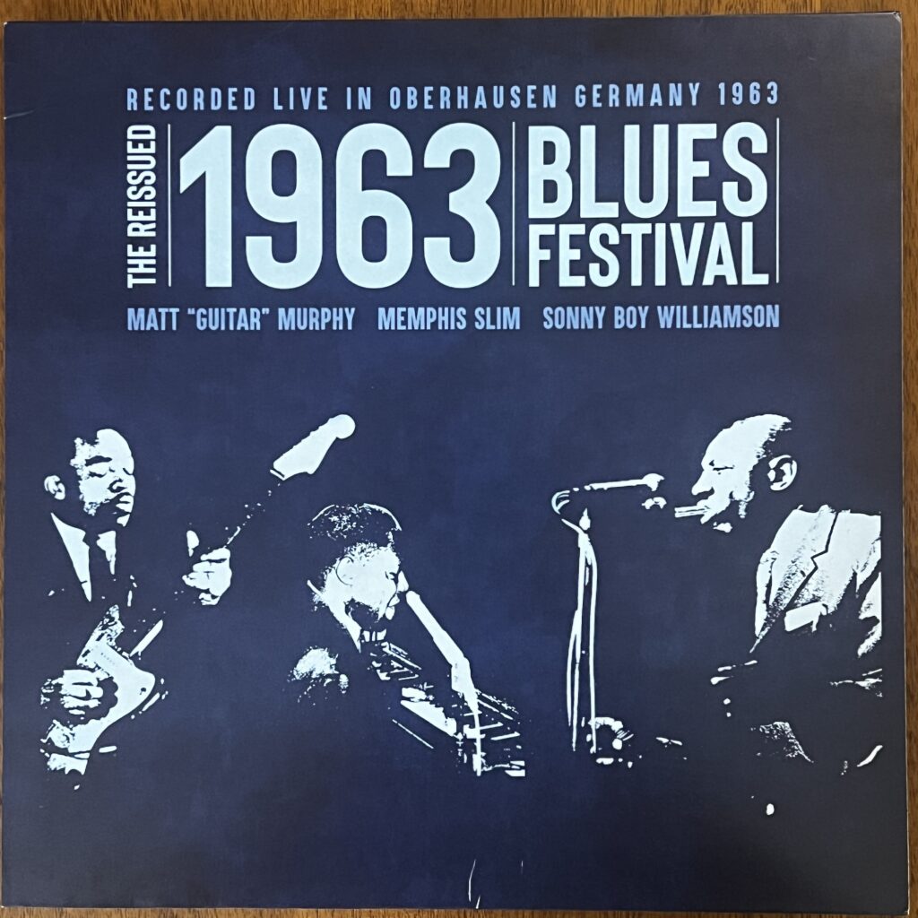 front cover of 1963 Blues Festival, recorded live in Oberhausen, Germany, 1963, with Matt "Guitar" Murphy, Memphis Slim, and Sonny Boy Williamson. Beneath the title are highly contrasted photographs of Murphy, holding his guitar, Memphis Slim at a keyboard and microphone, and Williamson playing harmonica into a microphone.